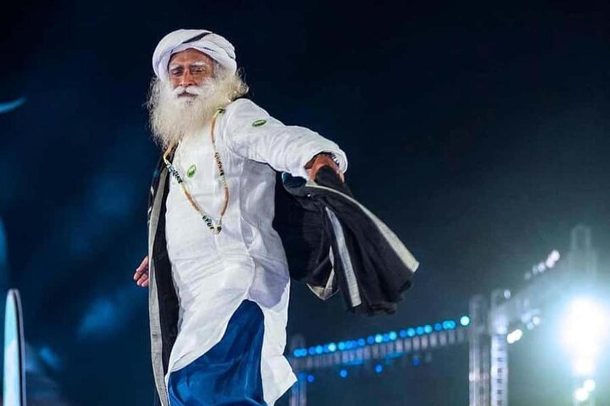 a man with a long beard walking on a stage