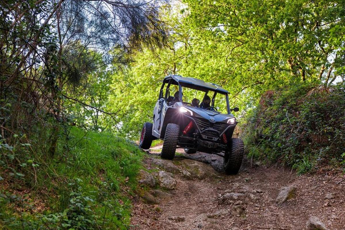 a atv driving down a dirt trail