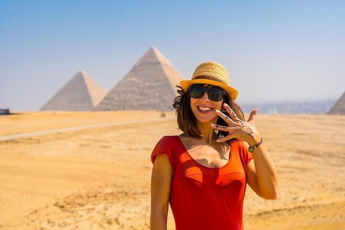 a woman talking on a cell phone in front of pyramids
