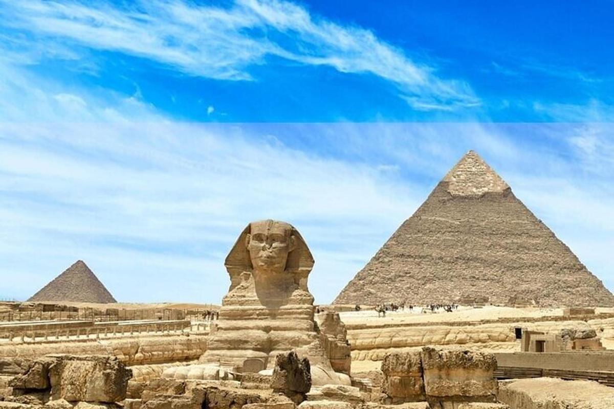 a large statue in front of the pyramids