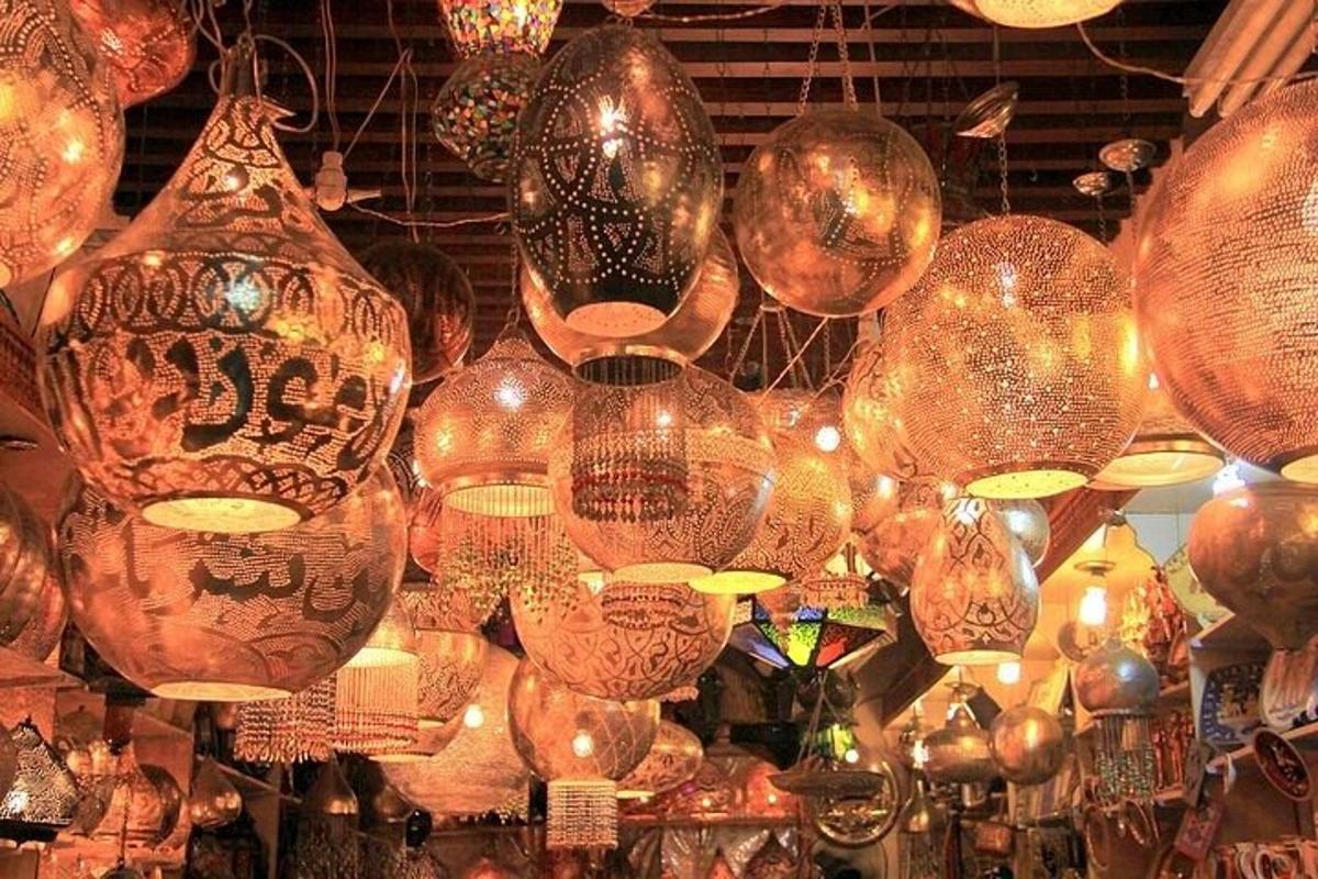 a bunch of glass lanterns hanging in a store