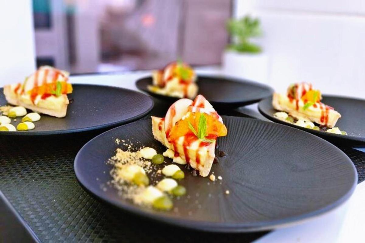 four black plates of food on a table