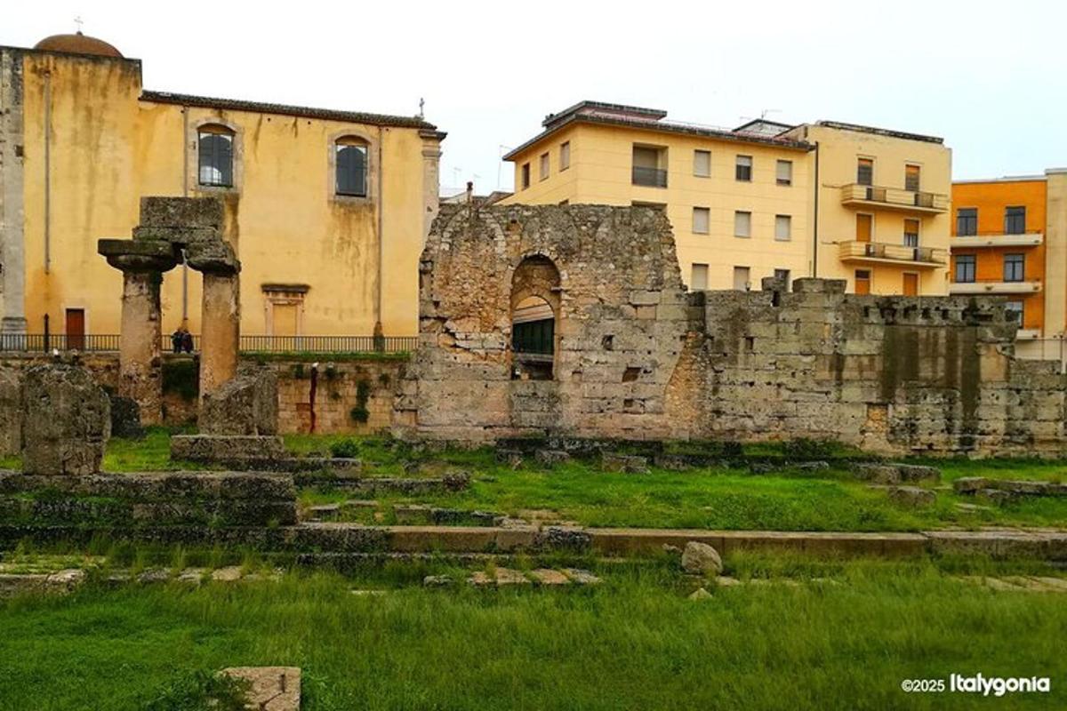un zid vechi de piatră cu clădiri în fundal