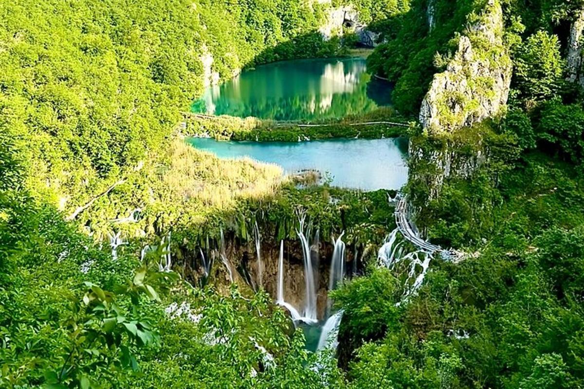 a waterfall in the middle of a mountain with trees
