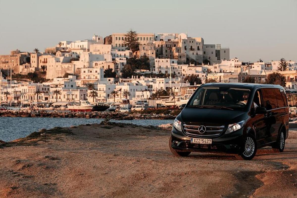 a small black car parked in front of a city