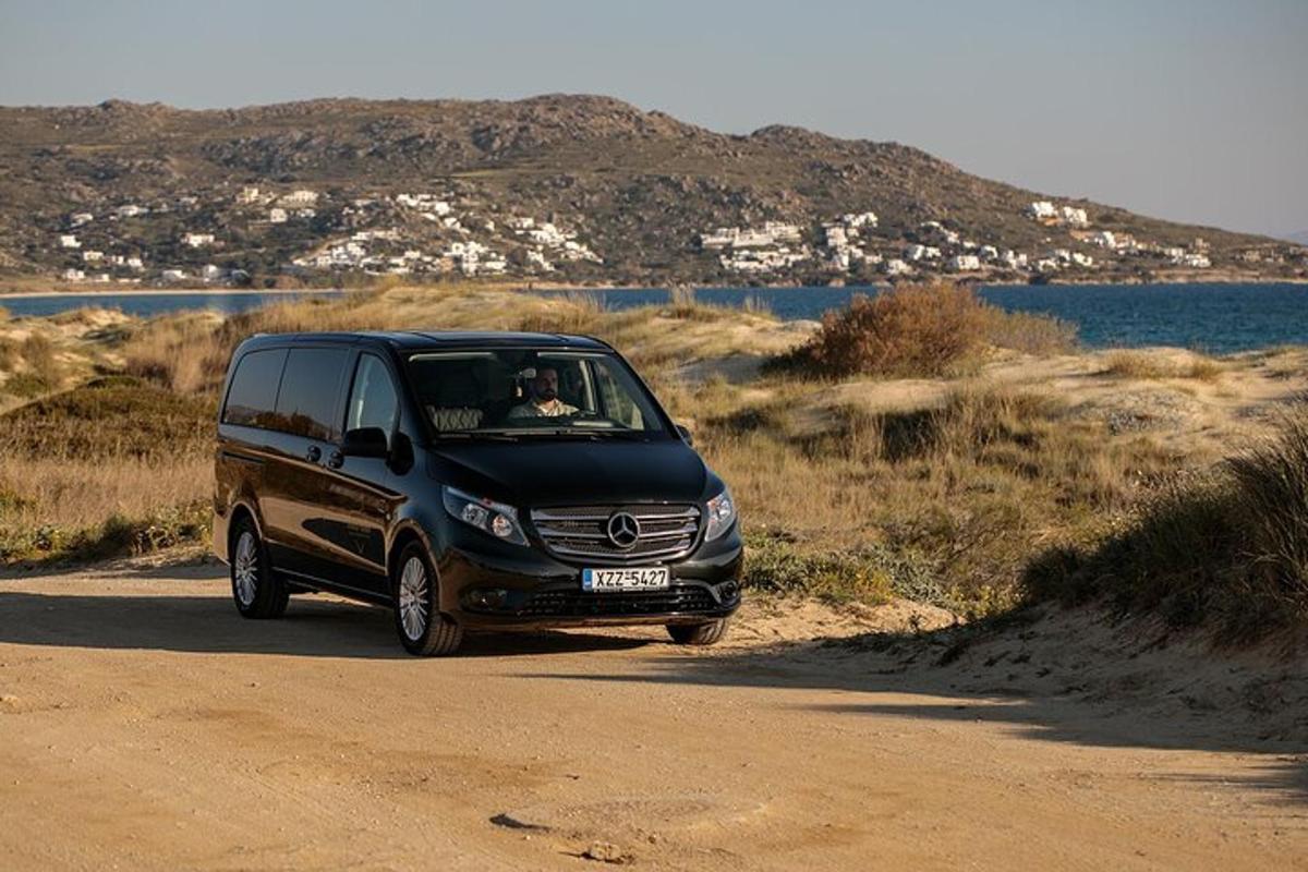a black van driving down a dirt road