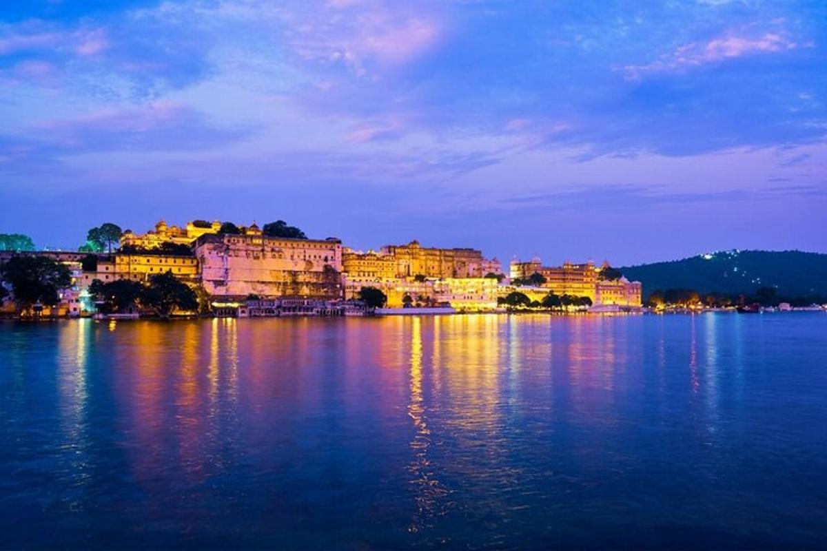 a group of buildings on the water at night