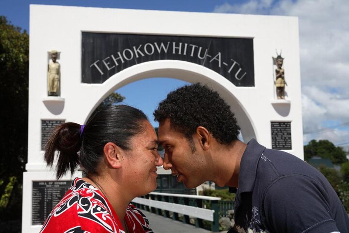 a man and a woman standing in front of a sign