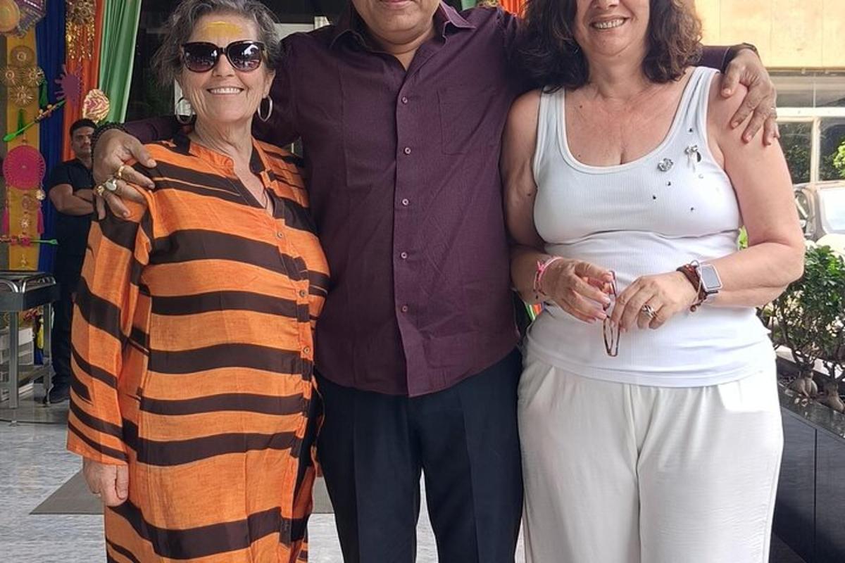 a man and two women standing next to each other