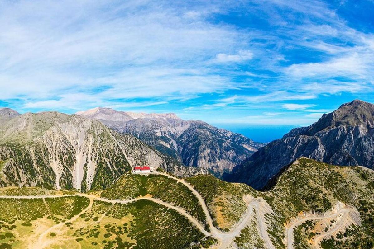 a red house on the side of a mountain
