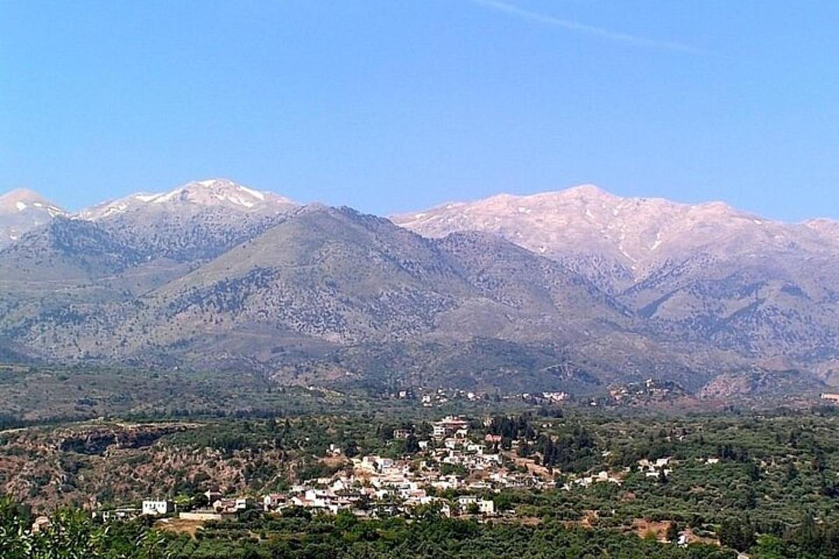 a mountain range with a town in front of a city
