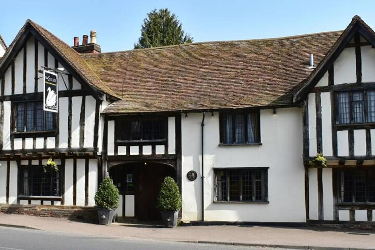 an old black and white building with a garage