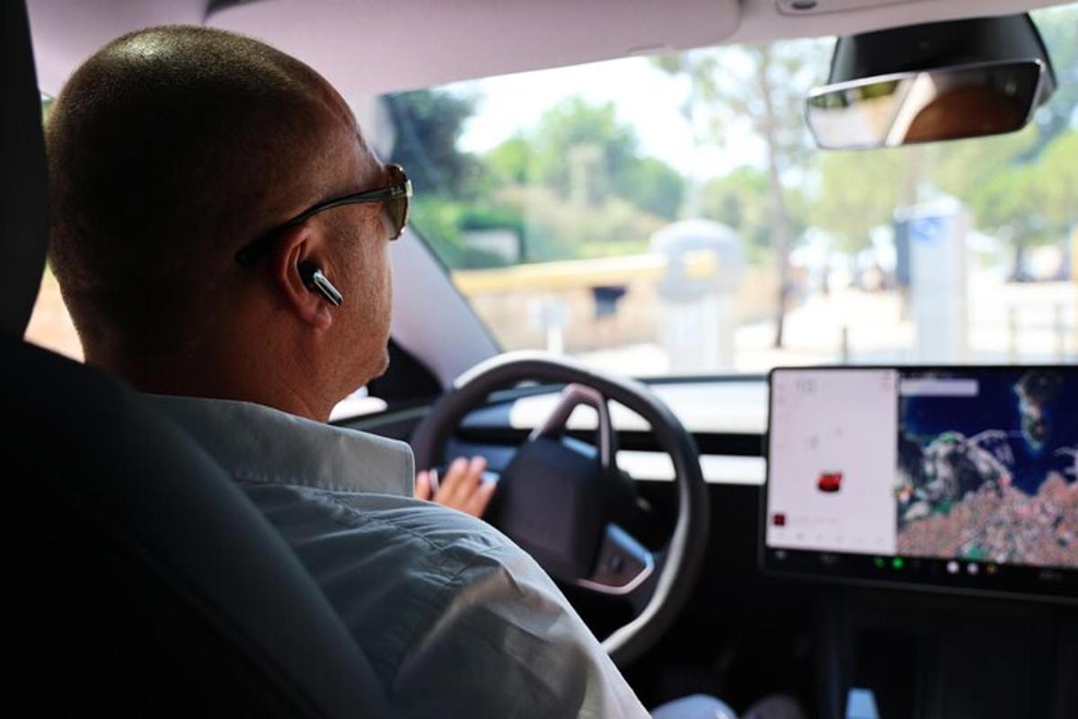 um homem dirigindo um carro com um laptop