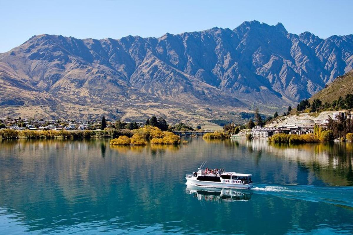 a boat on a lake with mountains in the background