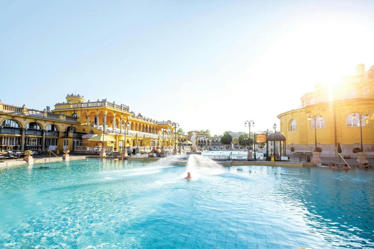a fountain in the middle of a city with buildings