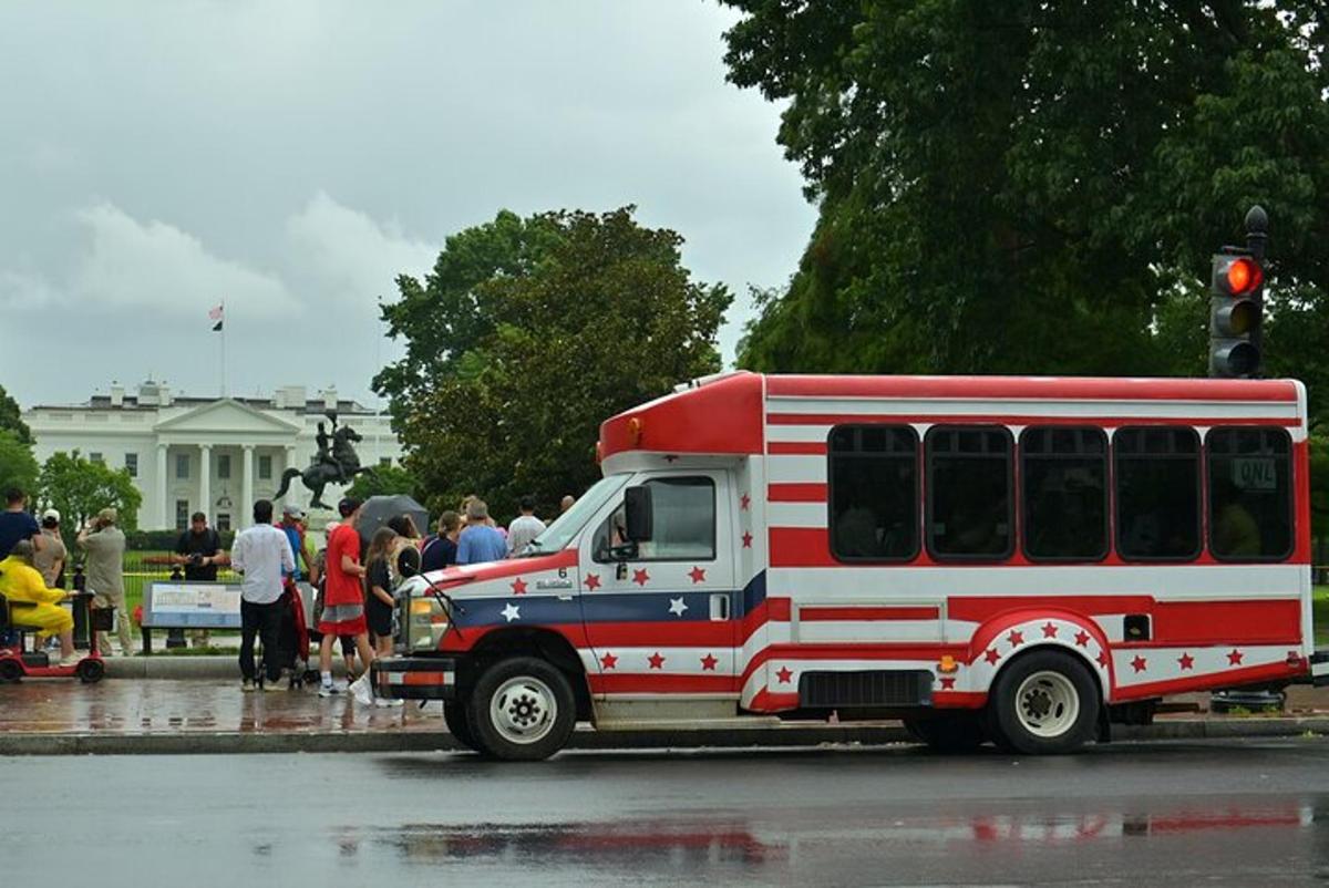 a red and white fire truck driving down a street