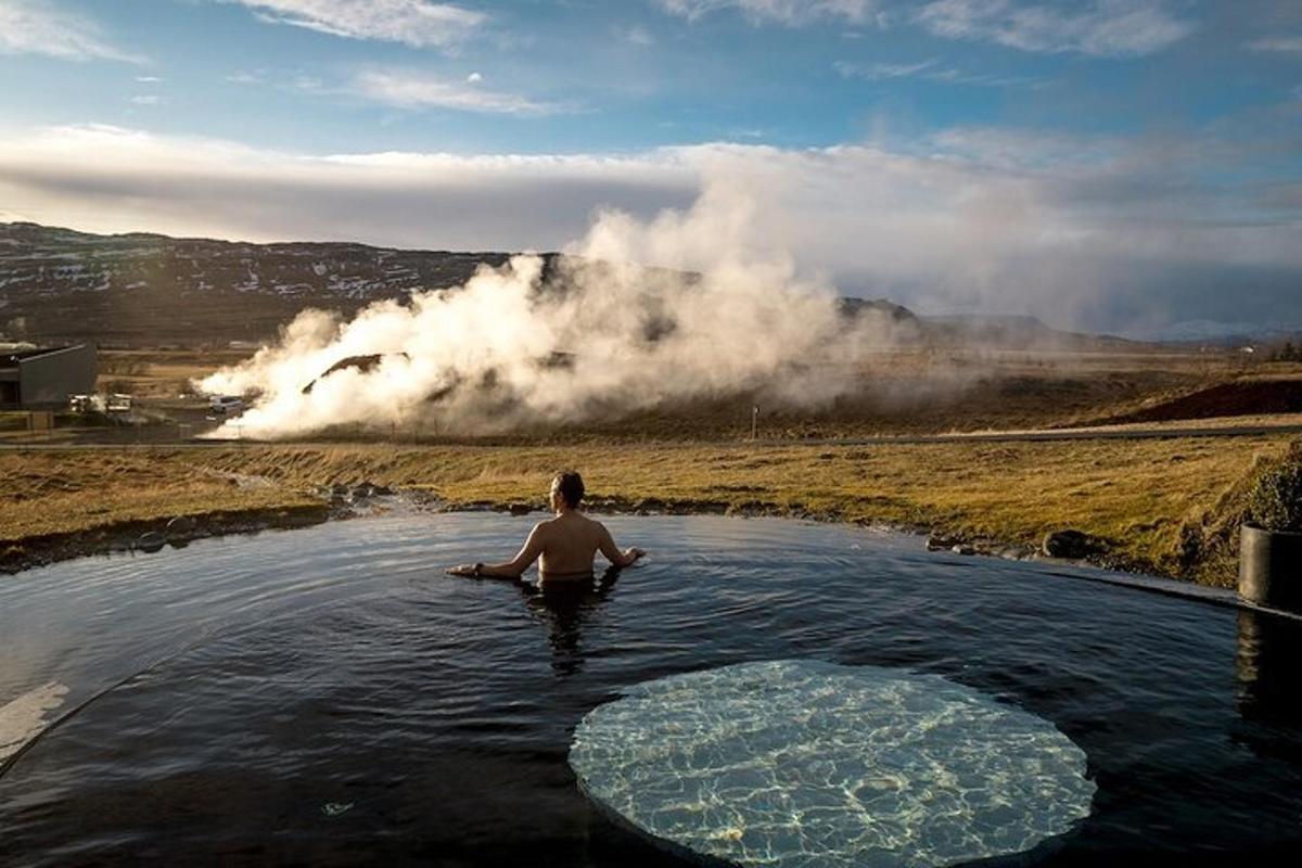 a man is in a hot tub in a river