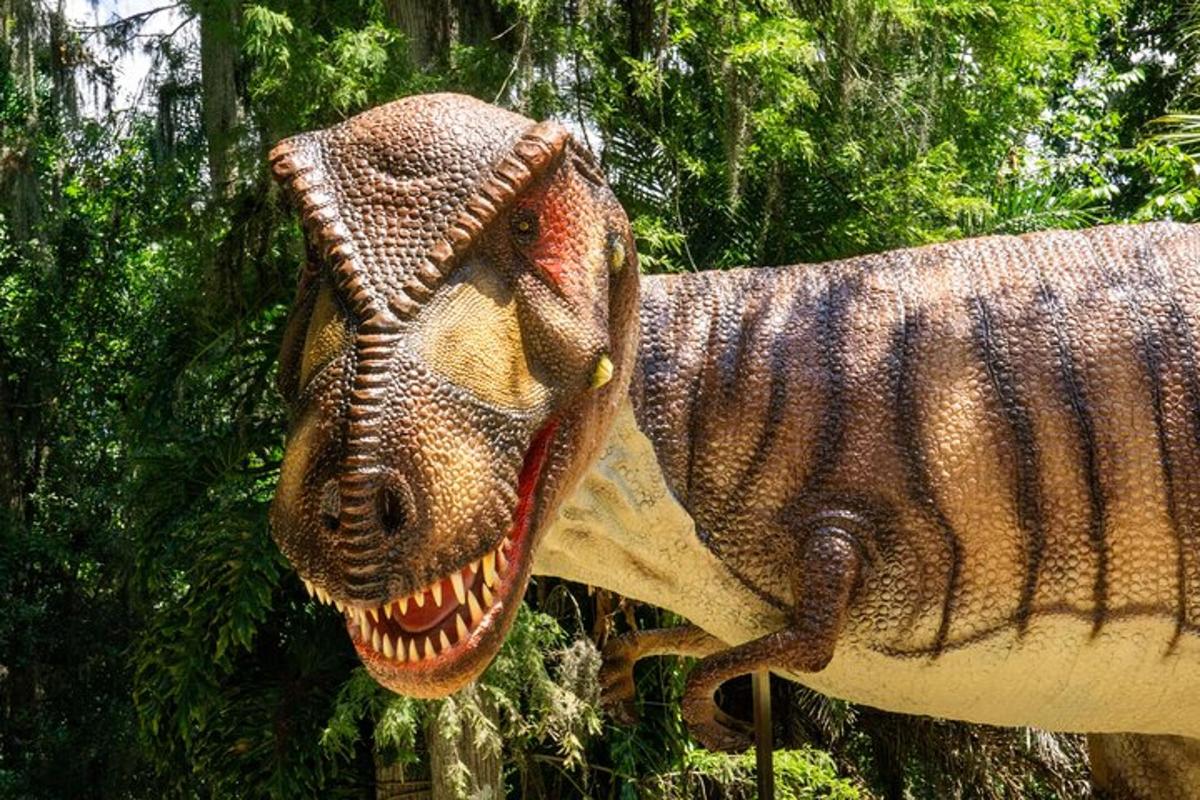 a statue of a dinosaur with its mouth open