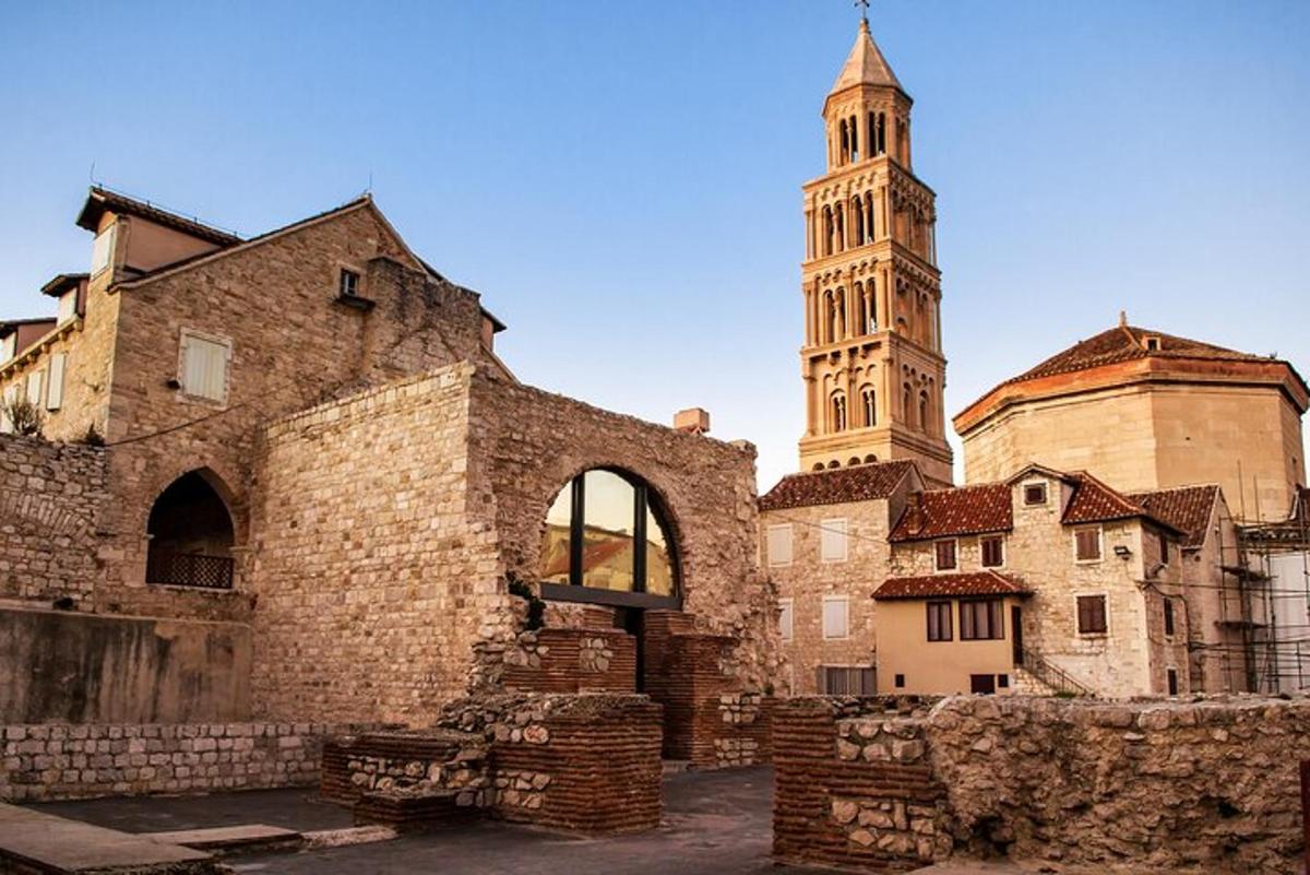 an old stone building with a tower and a church