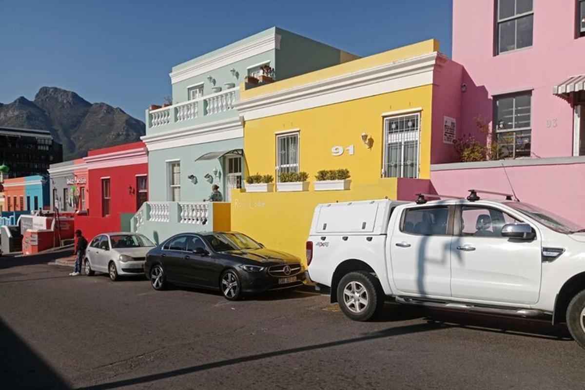 a white truck parked in front of a row of houses