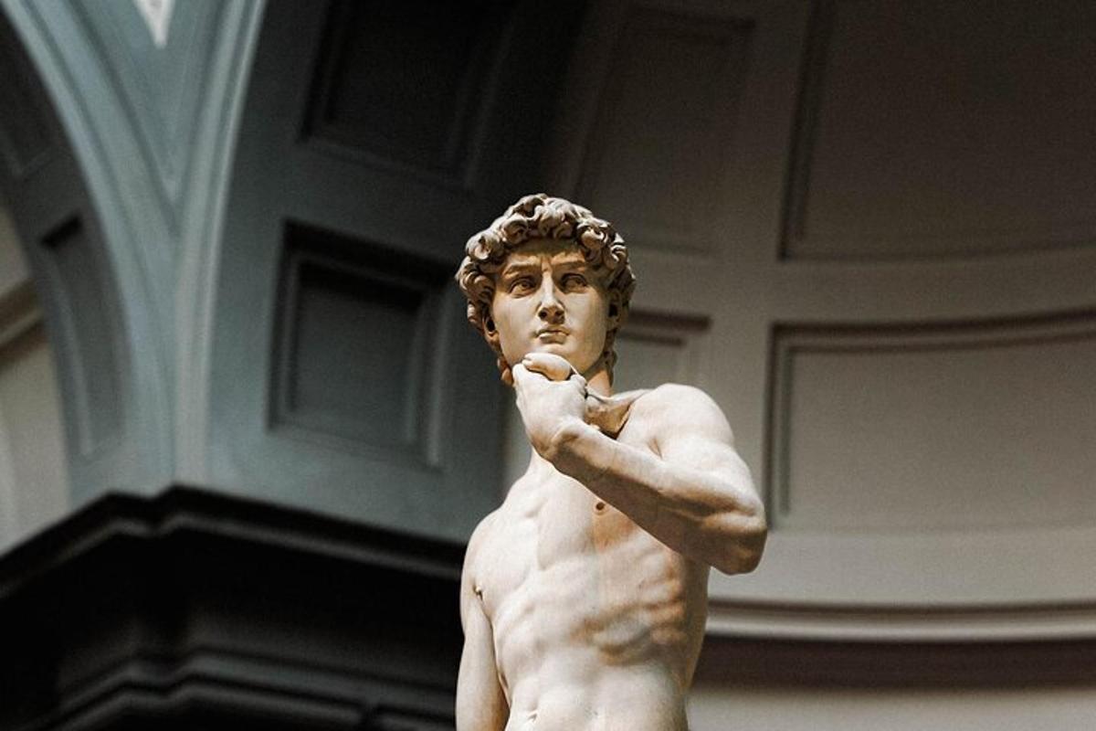 a statue of a naked man brushing his teeth