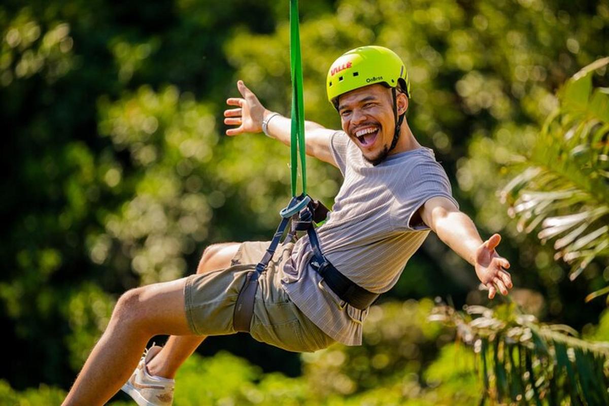 a man in a helmet is on a zip line