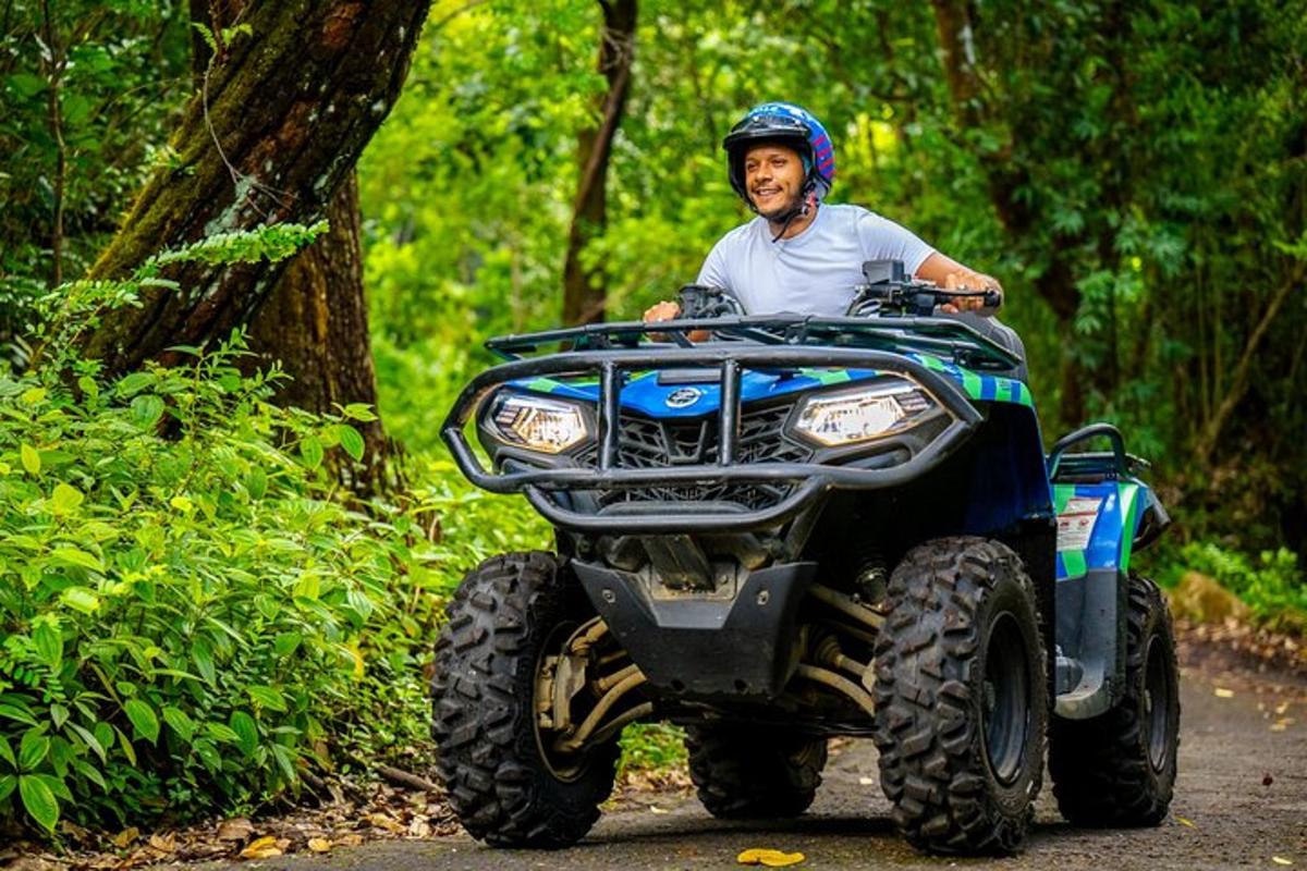 a man riding a atv down a trail