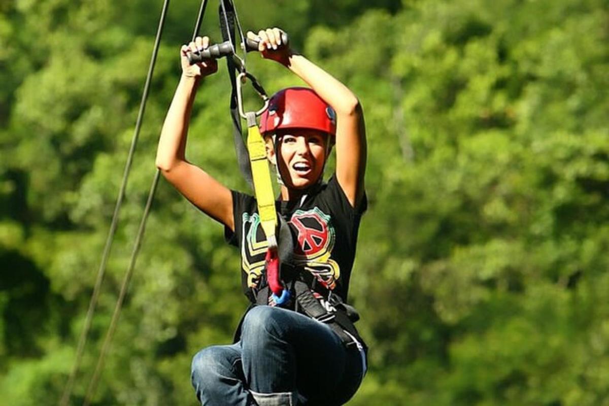 a man holding onto a rope while on a zip line