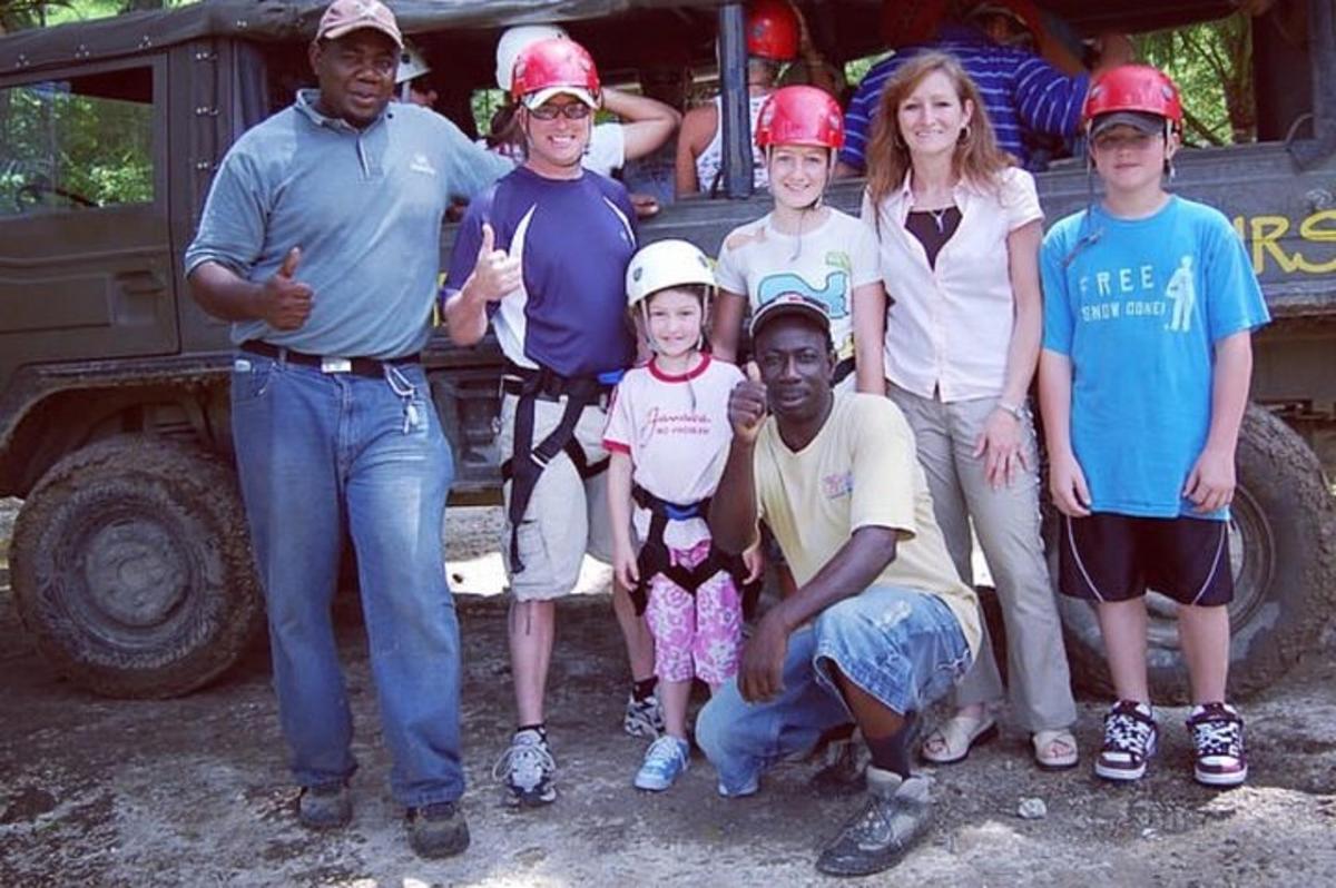 a group of people posing for a picture in front of a truck