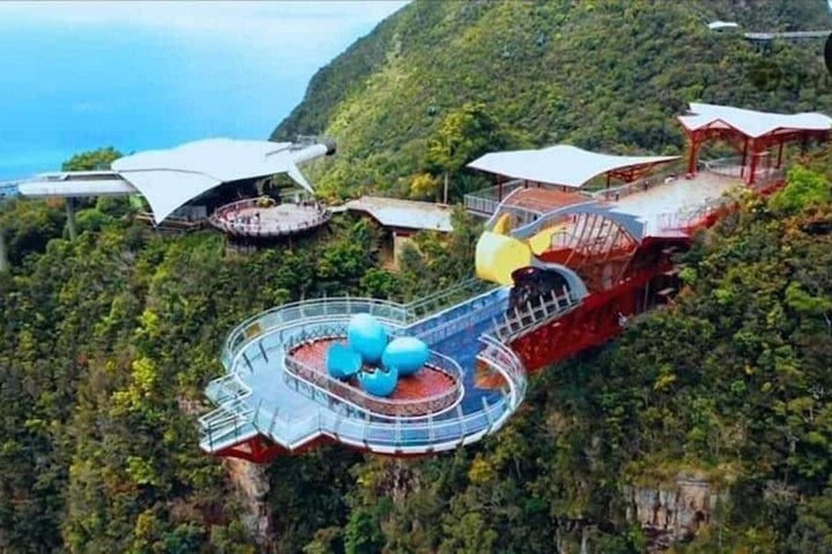 a water slide on a mountain with a train