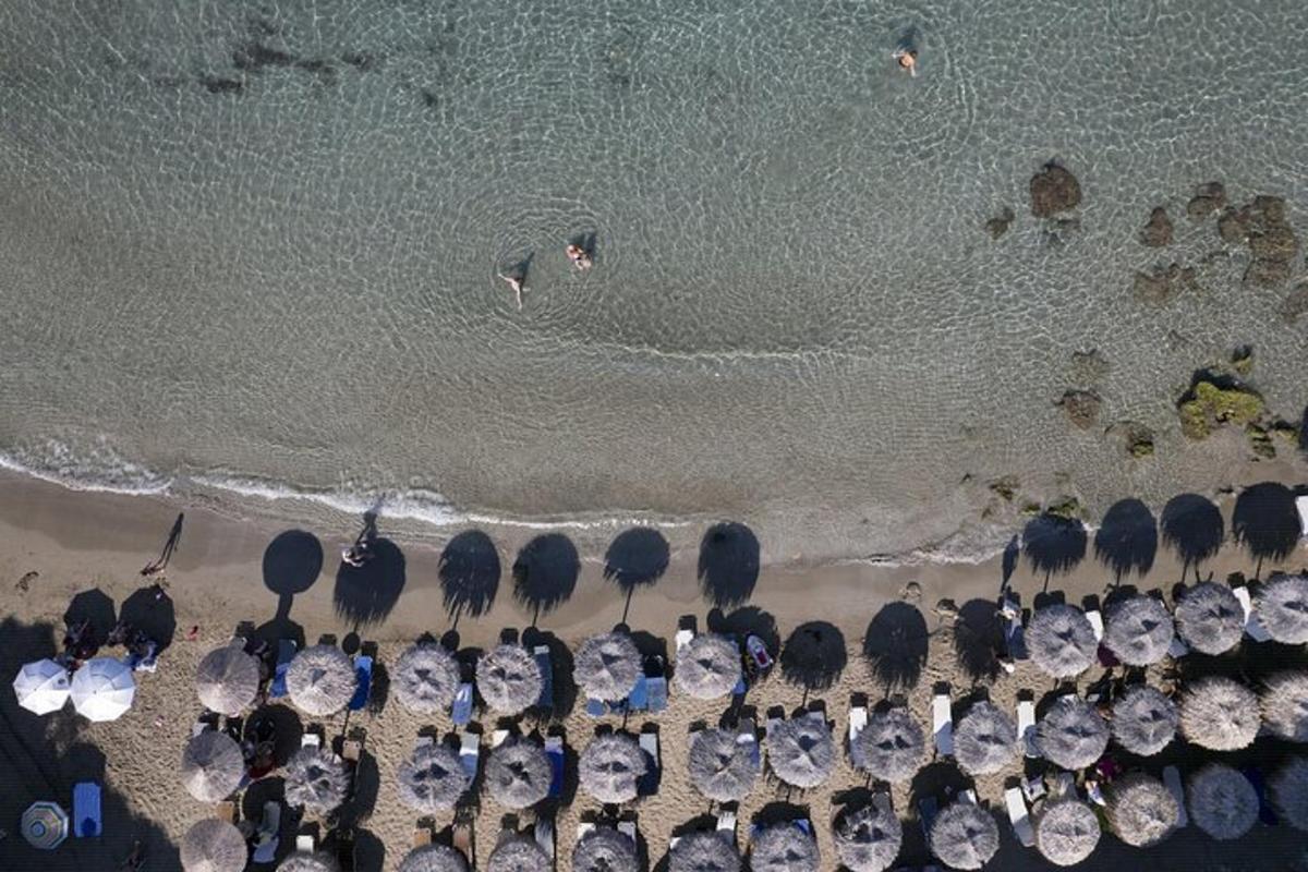 an aerial view of a beach with a group of umbrellas