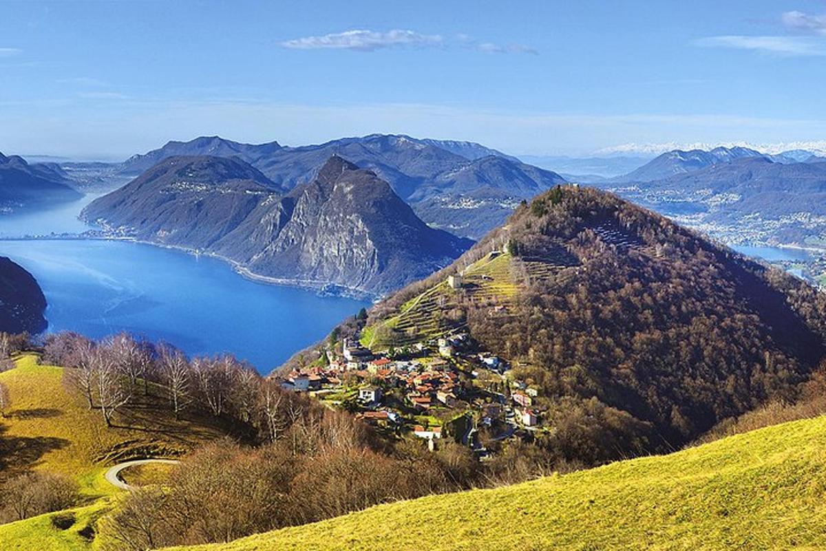 a town on top of a mountain with a body of water