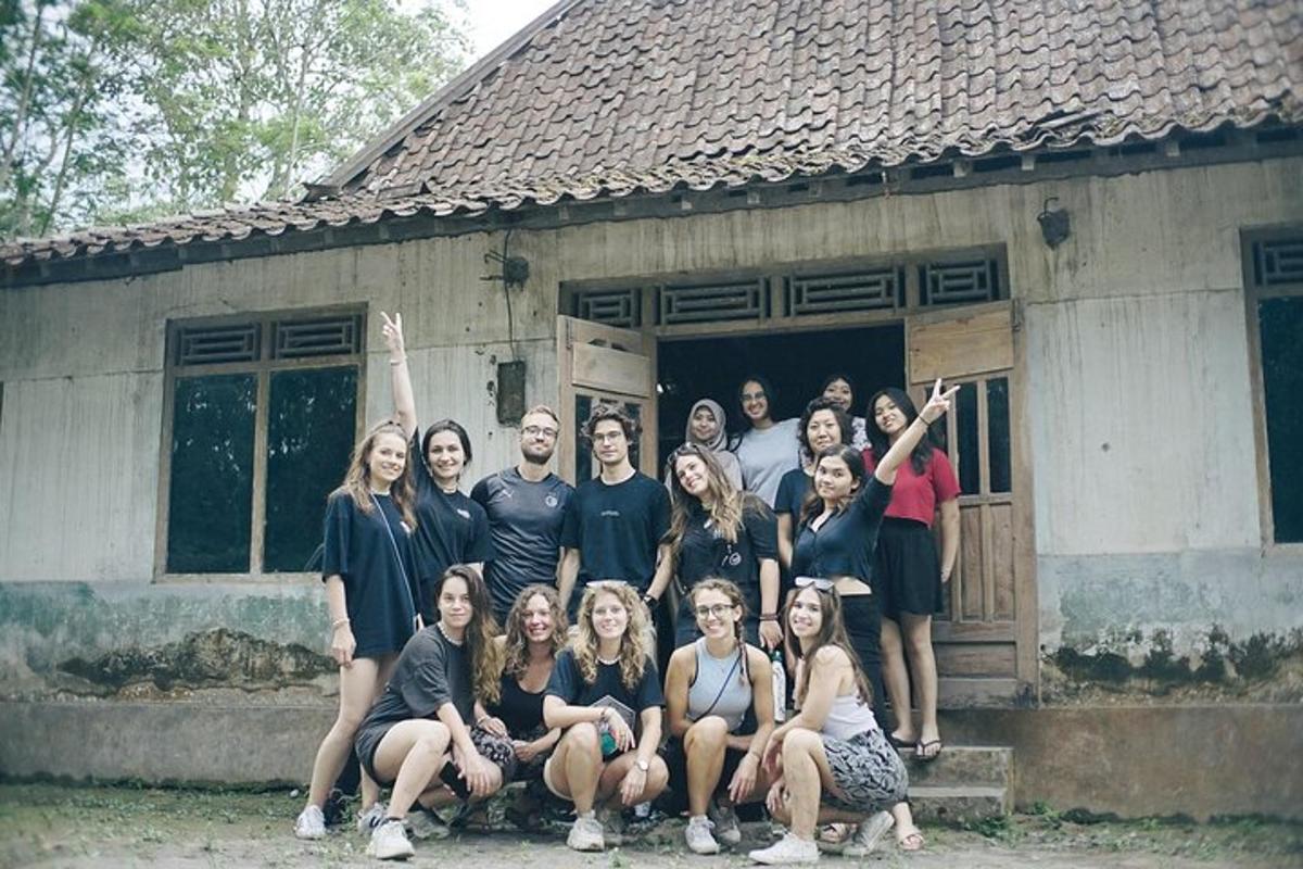 a group of people posing in front of a house