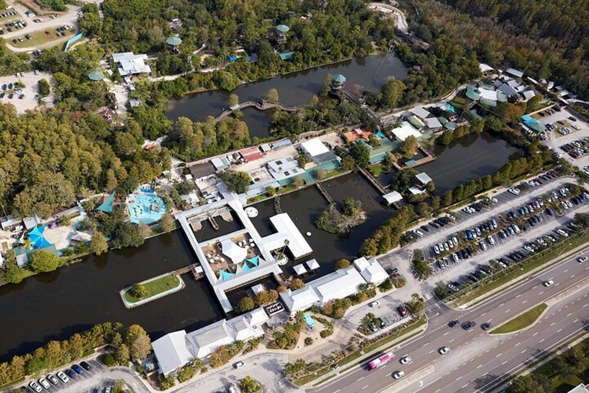 an aerial view of a resort next to a river
