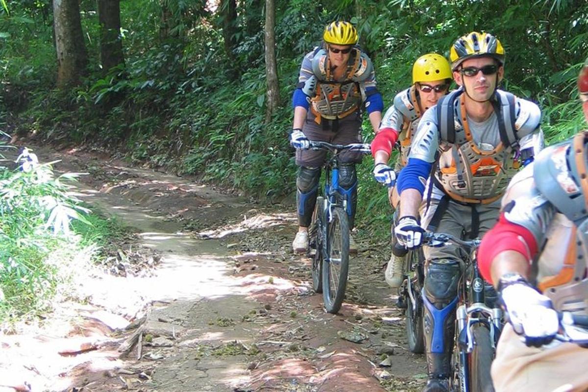 a group of people riding bikes down a trail