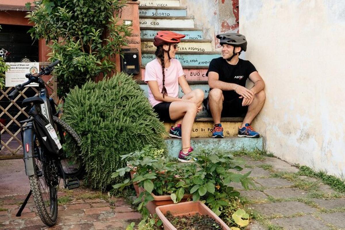 un uomo e una donna seduti sulle scale con i caschi in testa
