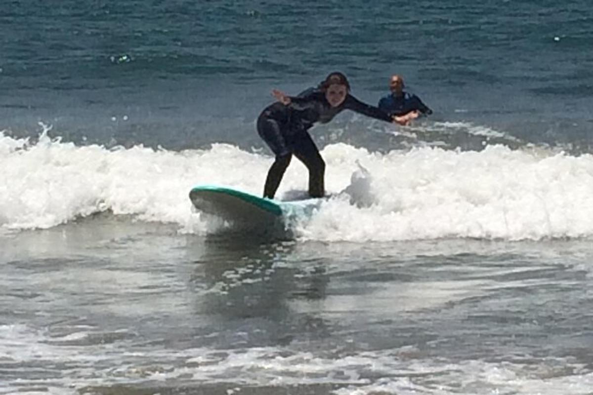 a woman riding a wave on a surfboard in the ocean