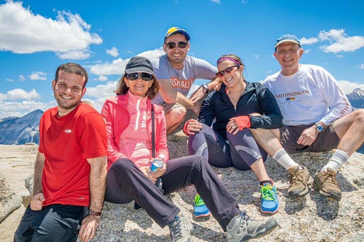 a group of people sitting on top of a mountain