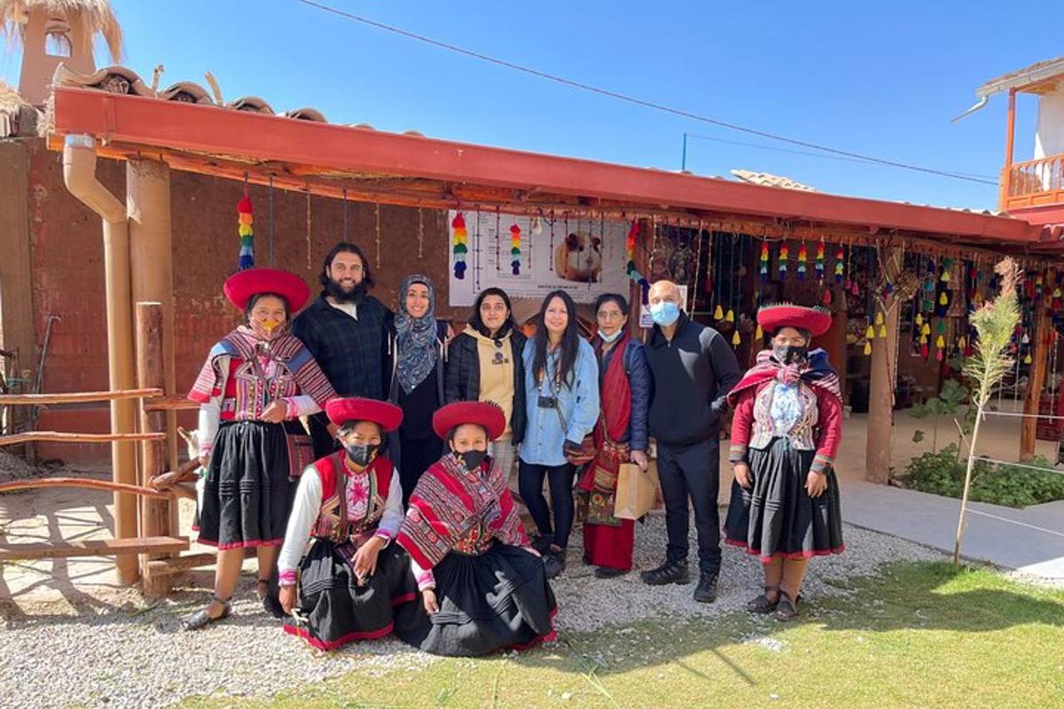 a group of people posing for a picture in front of a building