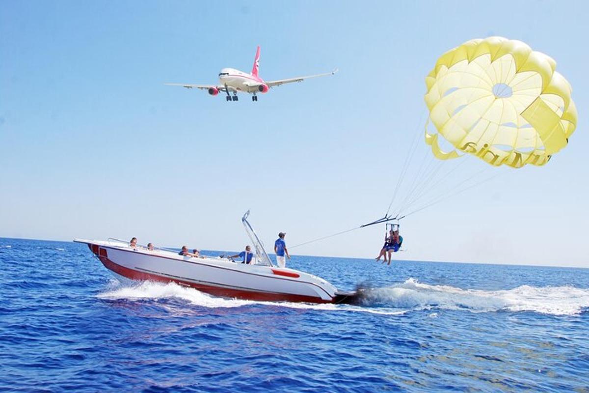 a group of people on a boat in the water with a plane