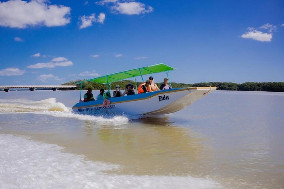 a group of people riding in a boat on the water