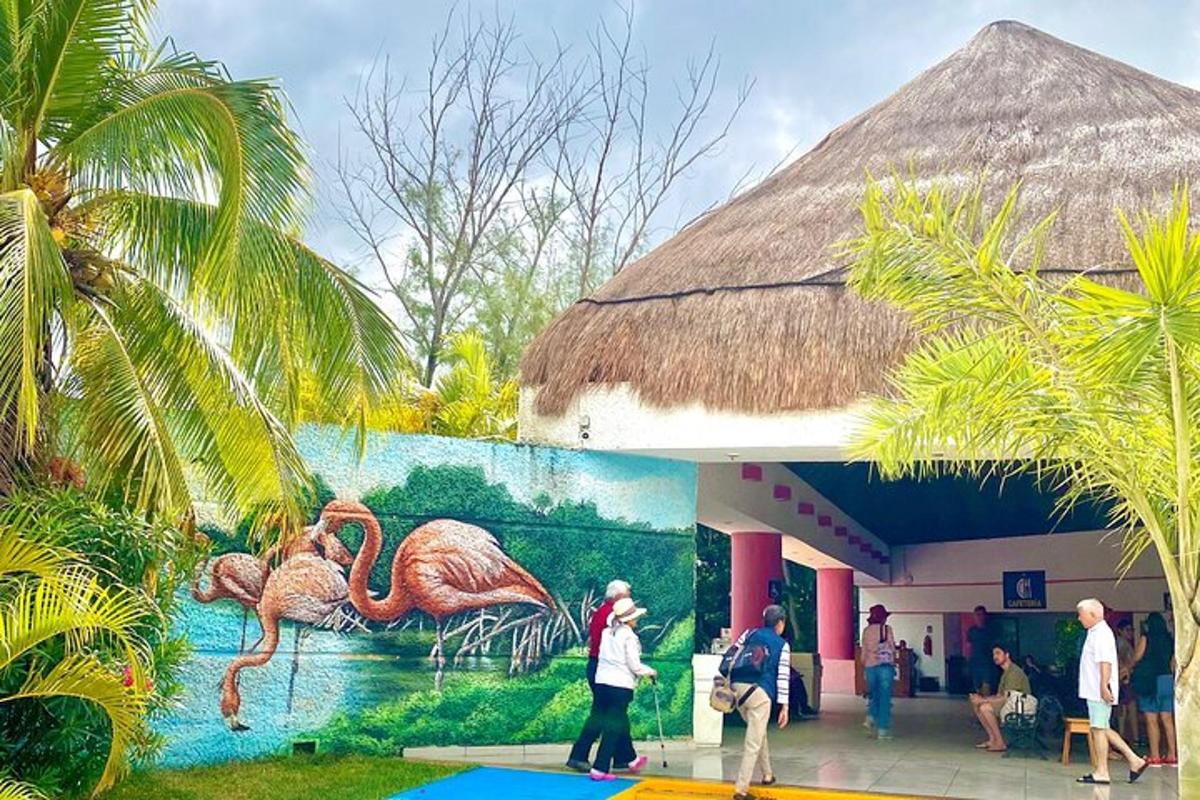 people walking in front of a building with a painting of birds
