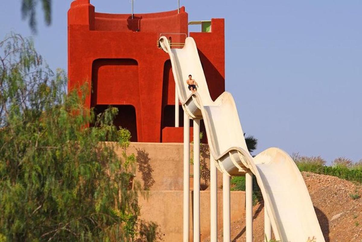 a group of slides in front of a red building
