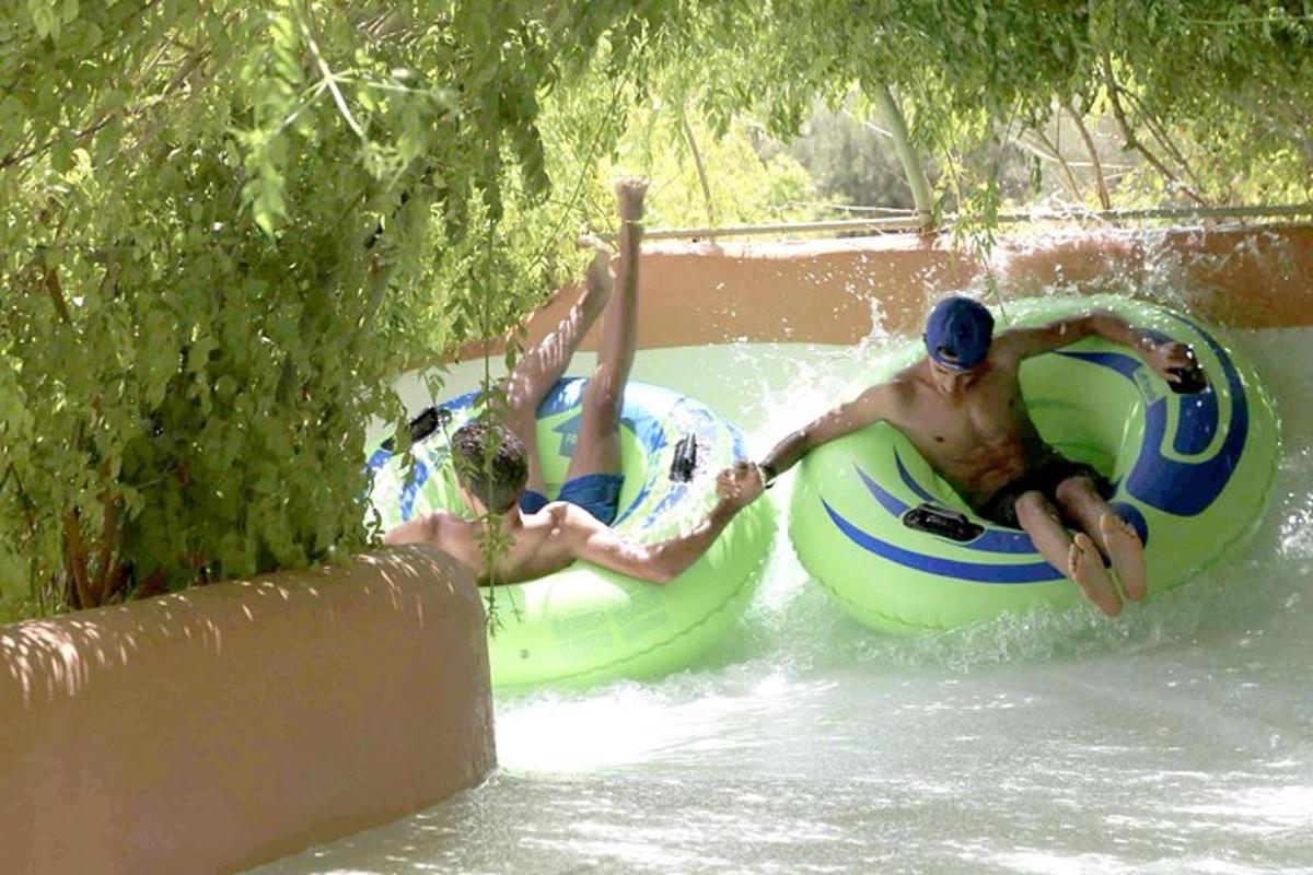 two men are riding on inflatables in the water