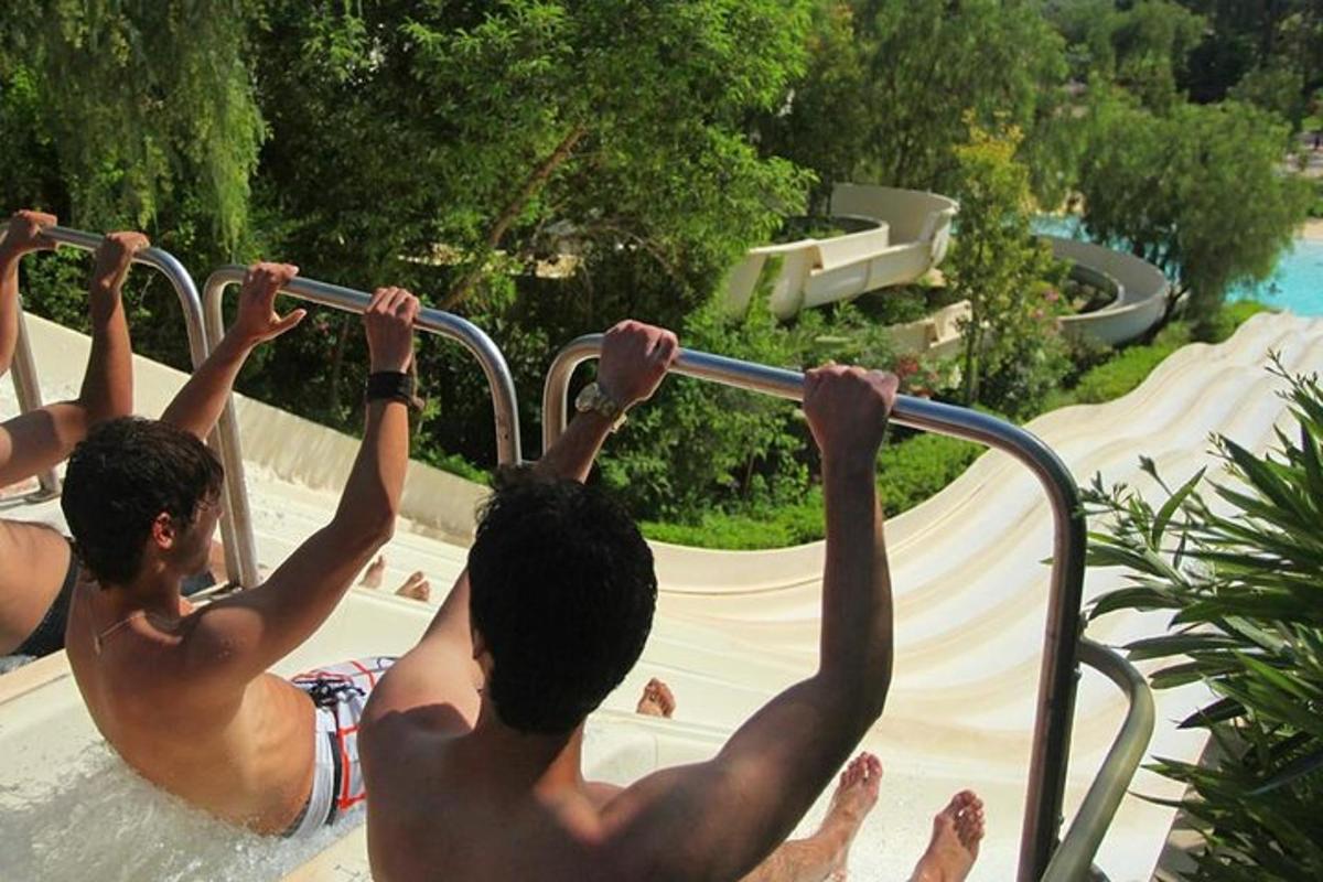 two men holding onto a rail in a swimming pool