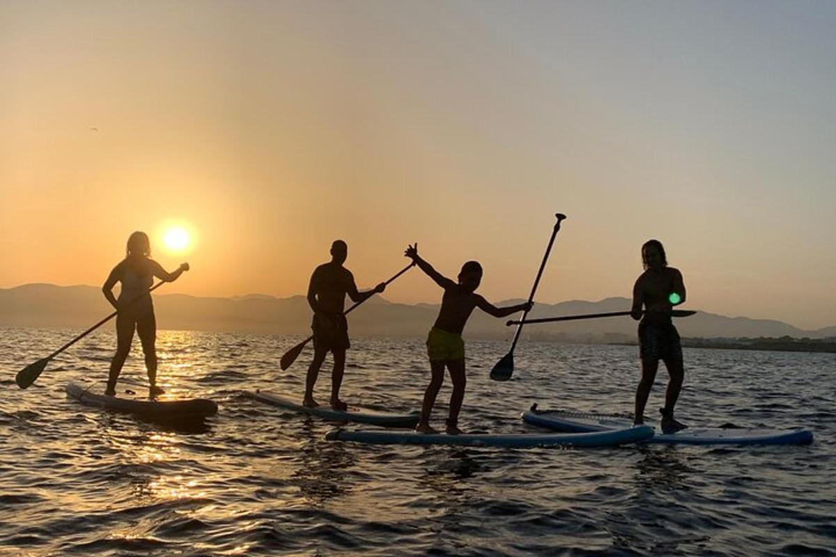 a group of people on a paddle board in the water