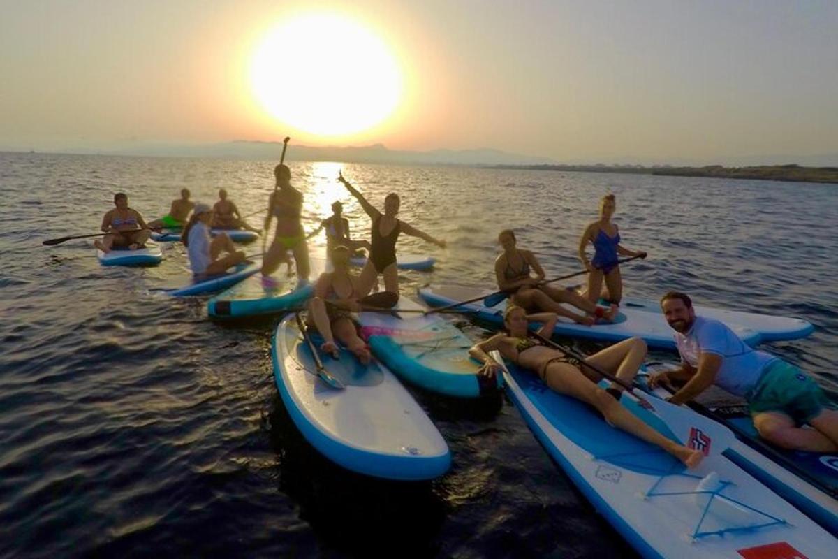 a group of people sitting on kayaks in the water