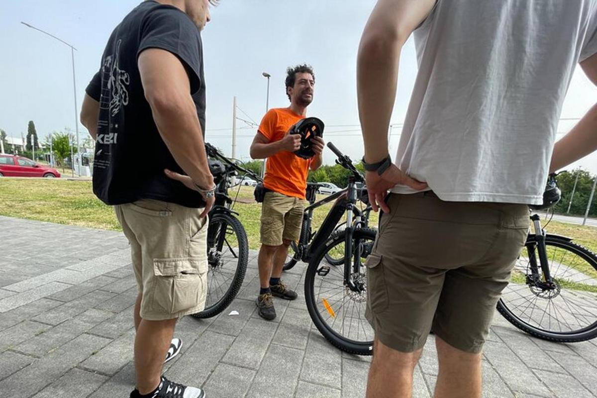 a man taking a picture of three men with bikes