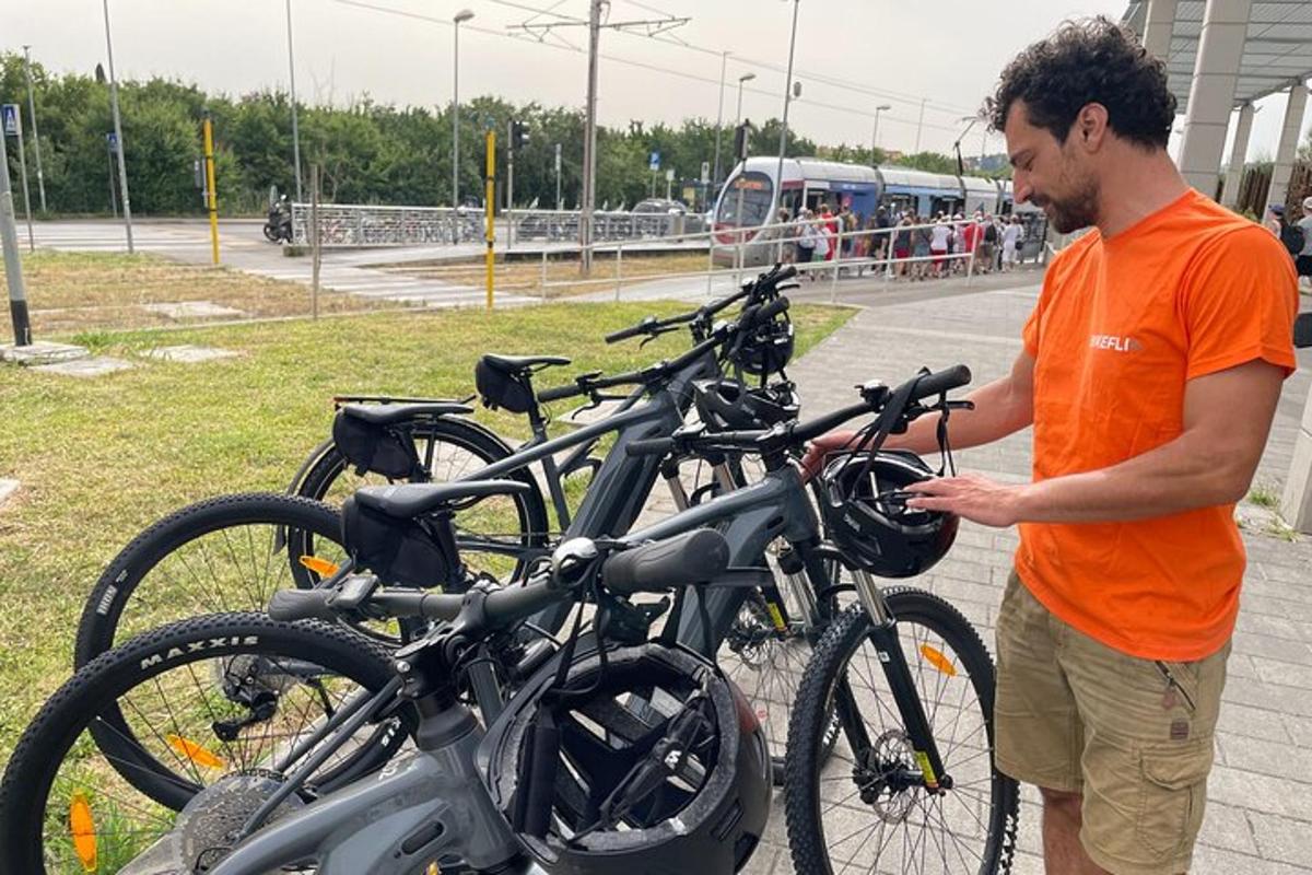 a man standing next to a row of bikes