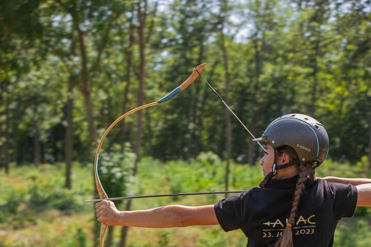 a woman is holding a bow and arrow